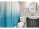Bright bathroom featuring a blue ombre shower curtain, a sleek vanity, and modern fixtures at 6307 Keeneland Ct, Indianapolis, IN 46278