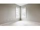 Neutral bedroom featuring two large windows, new carpeting, and soft, gray paint at 6307 Keeneland Ct, Indianapolis, IN 46278