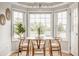 Bright dining area with modern table set, surrounded by large windows providing natural light at 6307 Keeneland Ct, Indianapolis, IN 46278