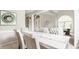 Bright dining room showcasing tufted chairs and natural light filtering through an arched window at 6307 Keeneland Ct, Indianapolis, IN 46278