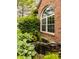 Attractive landscaping featuring a decorative pond, rocks and lush greenery near brick wall at 6307 Keeneland Ct, Indianapolis, IN 46278