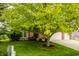 Charming brick home with a well-manicured lawn and mature tree in front at 6307 Keeneland Ct, Indianapolis, IN 46278