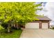Inviting brick home with a spacious two-car garage and a well-maintained driveway at 6307 Keeneland Ct, Indianapolis, IN 46278