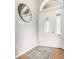 Bright foyer with a stylish front door, decorative oval mirror, and hardwood floors at 6307 Keeneland Ct, Indianapolis, IN 46278