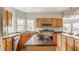 Bright kitchen with stainless steel appliances, wood cabinets, and a central island at 6307 Keeneland Ct, Indianapolis, IN 46278