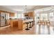 Bright eat-in kitchen with wood cabinets, stainless steel appliances, and breakfast bar at 6307 Keeneland Ct, Indianapolis, IN 46278
