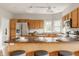 Kitchen with wood cabinets, stainless steel refrigerator, and breakfast bar with seating at 6307 Keeneland Ct, Indianapolis, IN 46278