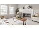 Bright and airy living room featuring a fireplace, two chairs and large windows at 6307 Keeneland Ct, Indianapolis, IN 46278