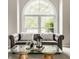 Living room featuring a large window and comfortable sofa, decorated with stylish accents at 6307 Keeneland Ct, Indianapolis, IN 46278