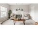 Elegant living room featuring a fireplace, comfortable armchairs and natural light at 6307 Keeneland Ct, Indianapolis, IN 46278