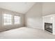 Bright living room with a vaulted ceiling, fireplace, and two windows offering ample natural light at 6307 Keeneland Ct, Indianapolis, IN 46278