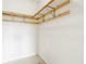 A walk-in closet with white walls and wood shelving offers ample storage at 6307 Keeneland Ct, Indianapolis, IN 46278
