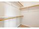 A walk-in closet with white walls and wood shelving offers ample storage at 6307 Keeneland Ct, Indianapolis, IN 46278