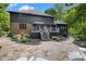 Two story home features a stone patio with steps up to a deck and a landscaped area with mature trees at 6350 Red Oak Dr, Avon, IN 46123