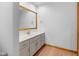 Bathroom featuring wood floor, white vanity, and large mirror at 6350 Red Oak Dr, Avon, IN 46123