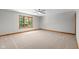 Spacious bedroom featuring neutral carpeting, large window, and a modern ceiling fan at 6350 Red Oak Dr, Avon, IN 46123