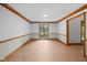 Unfurnished room with wood floors, white walls, and natural light at 6350 Red Oak Dr, Avon, IN 46123