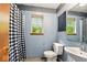 Full bathroom with window, sink, toilet, and shower with black and white curtain at 6396 Granny Smith Ln, Avon, IN 46123