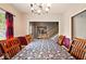 Formal dining room with wood chairs, table, chandelier, and view of staircase at 6396 Granny Smith Ln, Avon, IN 46123