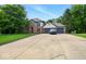 Long concrete driveway leading up to the two-car garage of this well-maintained, brick faced home at 6396 Granny Smith Ln, Avon, IN 46123
