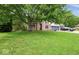 Brick home with large tree, green lawn, two-car garage, and blue trim and garage doors at 6396 Granny Smith Ln, Avon, IN 46123