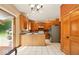 Open kitchen floor plan with stainless steel refrigerator, wooden cabinets, and island at 6396 Granny Smith Ln, Avon, IN 46123