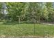 A green backyard with lots of mature trees at 671 Sonoma Ln, Greenfield, IN 46140