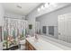 The bathroom offers a large mirror, modern fixtures and decorative shower curtain at 671 Sonoma Ln, Greenfield, IN 46140