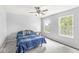 Bedroom with a ceiling fan and two large windows providing ample natural light at 671 Sonoma Ln, Greenfield, IN 46140