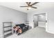 Sitting area in the bedroom with a ceiling fan, sofa, shelving unit, and door to the hallway at 671 Sonoma Ln, Greenfield, IN 46140