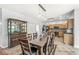 Dining area adjacent to kitchen, featuring a large wooden table and pendant lighting at 671 Sonoma Ln, Greenfield, IN 46140