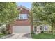 Charming two-story brick home featuring an attached garage and a well-maintained front yard at 671 Sonoma Ln, Greenfield, IN 46140