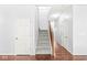 Foyer with hardwood flooring, carpeted staircase, and natural light at 671 Sonoma Ln, Greenfield, IN 46140