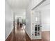 Open hallway featuring hardwood floors, light gray walls, and access to multiple rooms at 671 Sonoma Ln, Greenfield, IN 46140