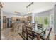 Open kitchen and dining area with island, stainless steel appliances, and sliding doors to the backyard at 671 Sonoma Ln, Greenfield, IN 46140