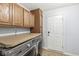 Convenient laundry room with countertop space, washer, and dryer, plus exterior access at 671 Sonoma Ln, Greenfield, IN 46140