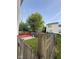 Backyard with grass, a wood fence, and a small deck at 6744 Redan Dr, Indianapolis, IN 46254