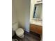 Half bath with white toilet, flooring and vanity with granite top at 6744 Redan Dr, Indianapolis, IN 46254