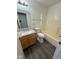 Clean bathroom with wood-look flooring, a vanity with a sink, toilet, and shower-tub combo at 6744 Redan Dr, Indianapolis, IN 46254