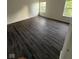 Well-lit bedroom featuring dark wood-look flooring, dual windows and neutral walls at 6744 Redan Dr, Indianapolis, IN 46254