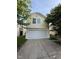 Charming two-story home featuring an attached two-car garage and mature trees at 6744 Redan Dr, Indianapolis, IN 46254