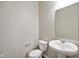 Powder room featuring pedestal sink, toilet, and mirror at 6830 Park Grove Blvd, Whitestown, IN 46075