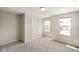 A bright bedroom featuring two windows and neutral carpet and paint at 6830 Park Grove Blvd, Whitestown, IN 46075