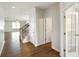 Open foyer view with hardwood floors leading to living area and stairs with carpeted steps at 6830 Park Grove Blvd, Whitestown, IN 46075