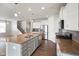 Eat-in kitchen featuring stainless steel appliances, a center island with granite countertops and wooden floors at 6830 Park Grove Blvd, Whitestown, IN 46075