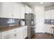 Bright kitchen featuring stainless steel appliances, beautiful granite countertops and white cabinets at 6830 Park Grove Blvd, Whitestown, IN 46075