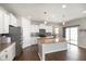 Bright eat-in kitchen featuring stainless steel appliances, a center island with granite countertops and wooden floors at 6830 Park Grove Blvd, Whitestown, IN 46075