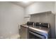 A laundry room features a modern silver washer and dryer, sink, and shelving at 6830 Park Grove Blvd, Whitestown, IN 46075