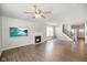 Bright living room with hardwood floors, fireplace, ceiling fan, and mounted television at 6830 Park Grove Blvd, Whitestown, IN 46075