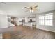 Expansive living room with hardwood flooring, open to kitchen, ceiling fan, and natural light at 6830 Park Grove Blvd, Whitestown, IN 46075
